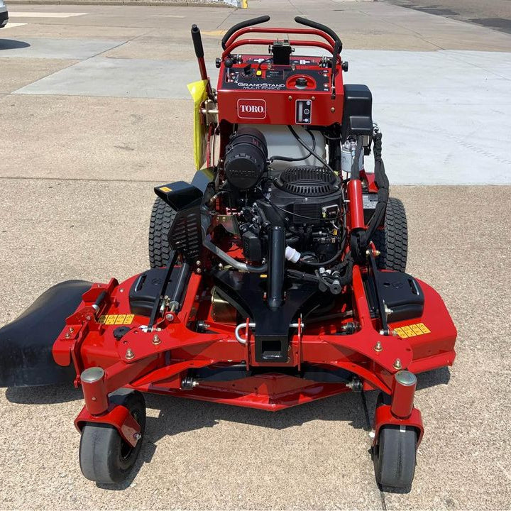 Toro Multiforce stand on commercial mower in parking lot  