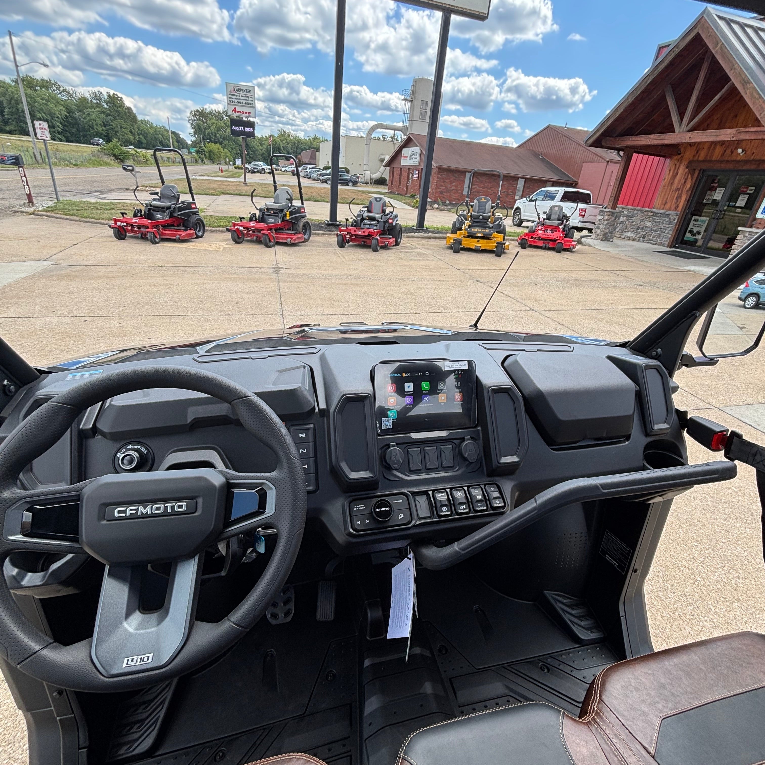 Interior of a Cfmoto side by side vehicle with a view of ProCore Power Equipment 