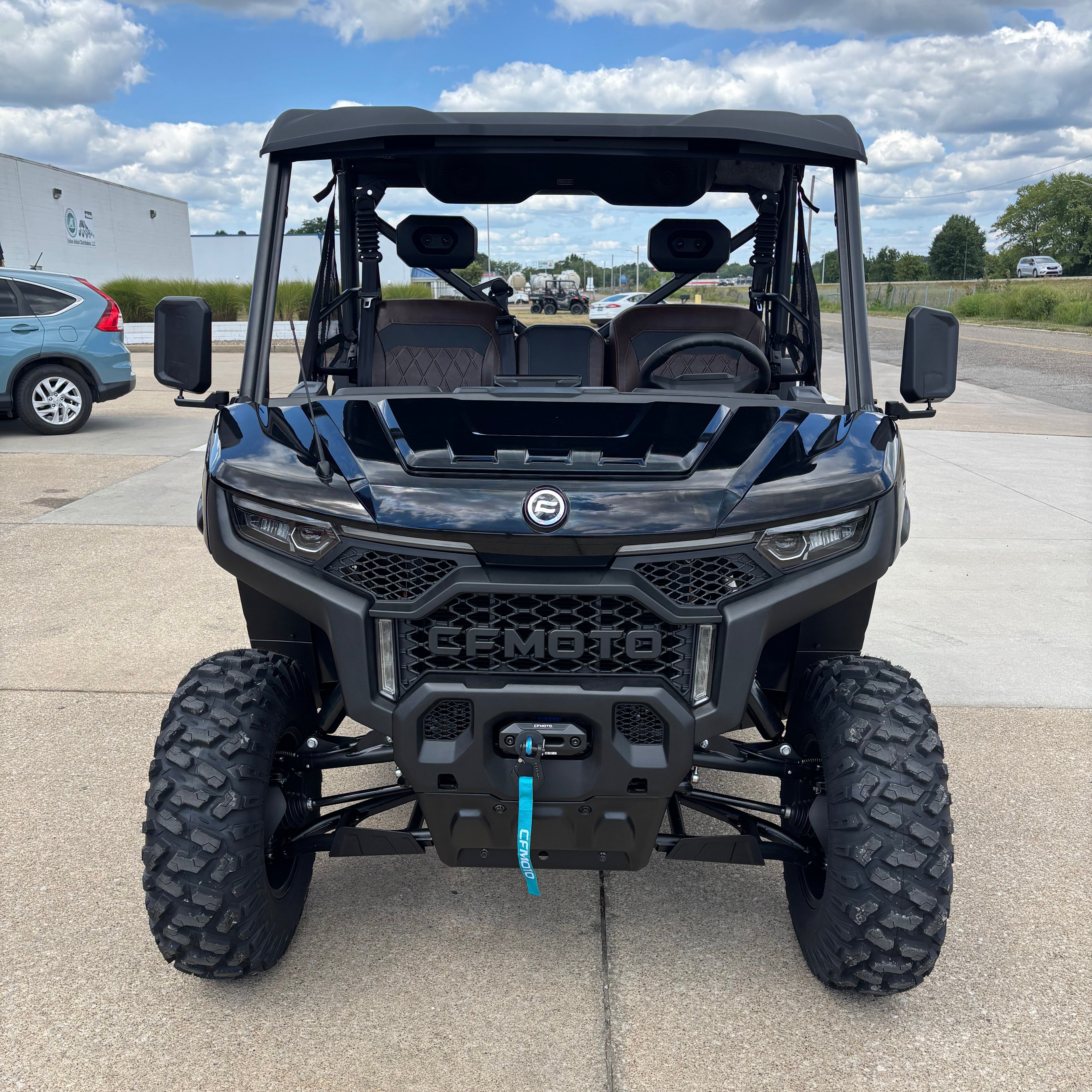 front view of cfmoto side by side in parking lot at dealership